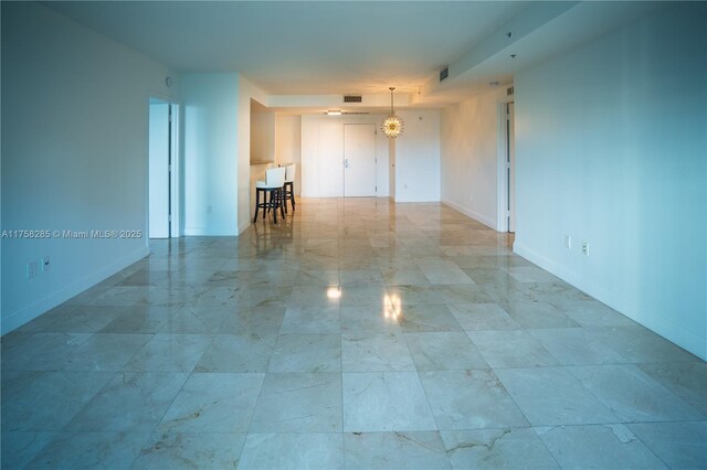3400 SW 27th Ave Unit 705, Miami, FL 33133 - spare room featuring baseboards, marble finish flooring, and a chandelier