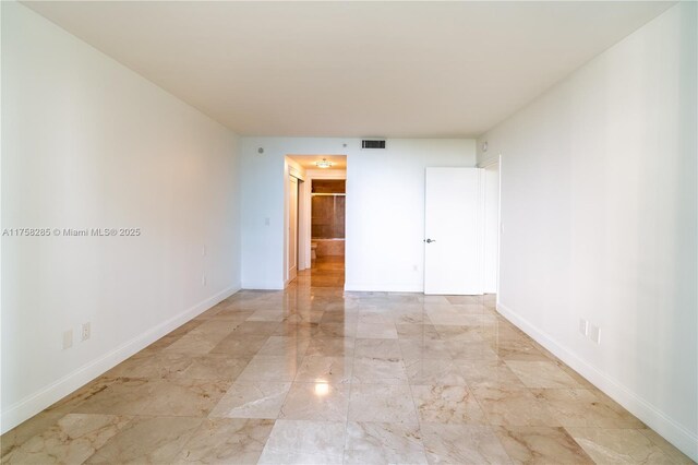 3400 SW 27th Ave Unit 705, Miami, FL 33133 - spare room featuring light marble finish flooring and baseboards
