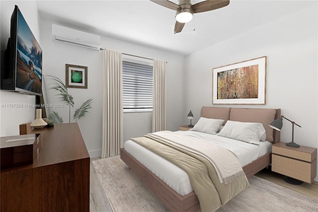 bedroom with ceiling fan, a wall mounted air conditioner, and wood finished floors