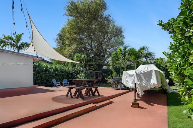 view of patio with a grill