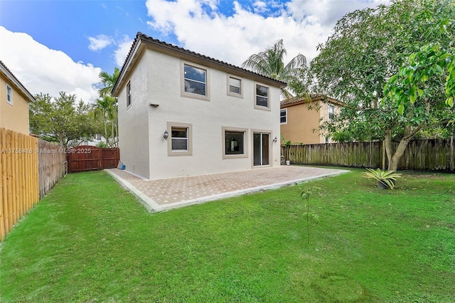 5220 SW 139th Ter, Miramar, FL 33027 - rear view of house with a patio area, a fenced backyard, stucco siding, and a tiled roof