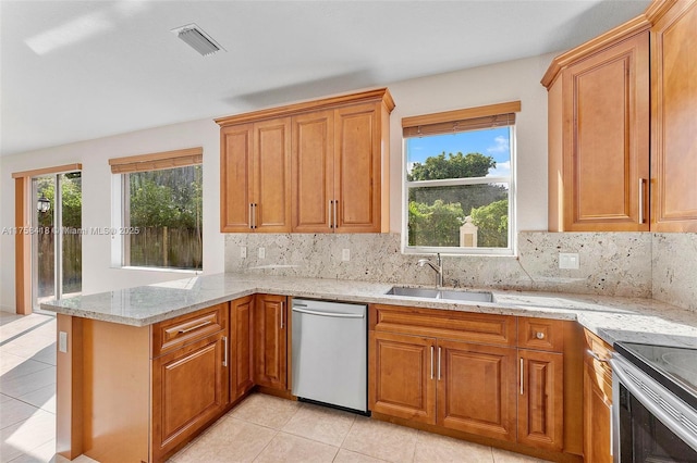5220 SW 139th Ter, Miramar, FL 33027 - kitchen with stainless steel appliances, light tile patterned flooring, a peninsula, and tasteful backsplash