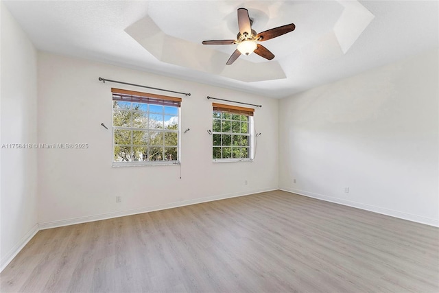 5220 SW 139th Ter, Miramar, FL 33027 - empty room with a raised ceiling, light wood-style floors, and a ceiling fan