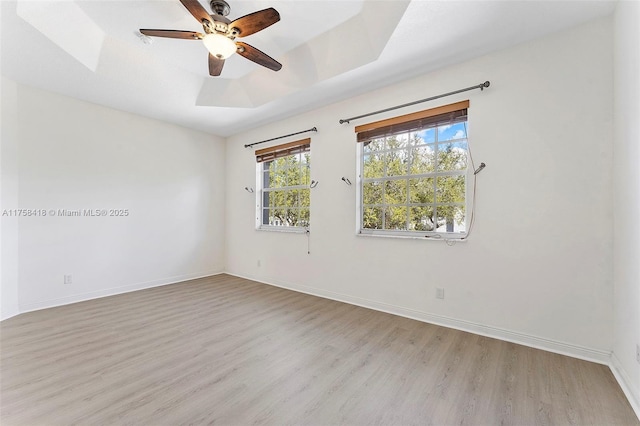 5220 SW 139th Ter, Miramar, FL 33027 - unfurnished room featuring light wood-style floors, a tray ceiling, and ceiling fan