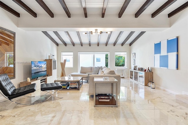 living room featuring marble finish floor, baseboards, and beamed ceiling