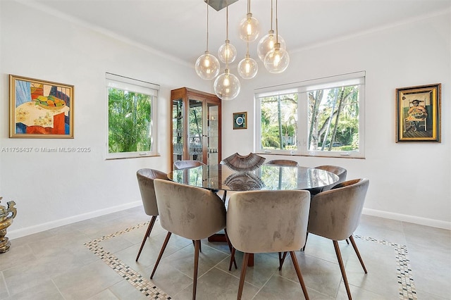 dining space with baseboards and light tile patterned floors