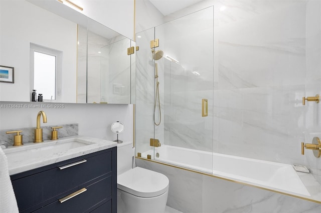 bathroom featuring enclosed tub / shower combo, toilet, and vanity