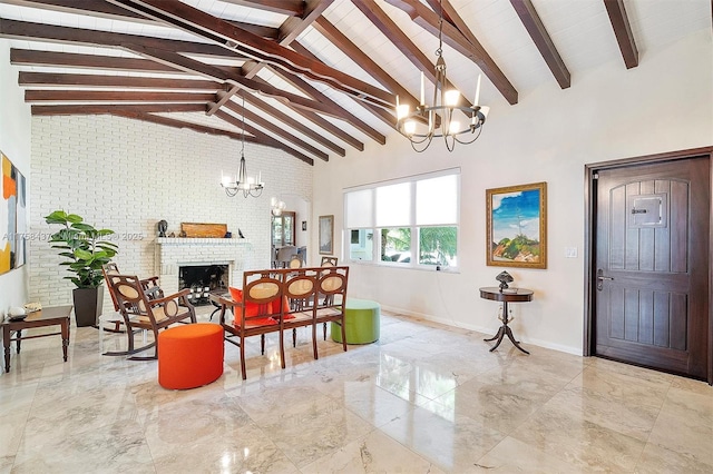 interior space featuring marble finish floor, a notable chandelier, a brick fireplace, brick wall, and high vaulted ceiling