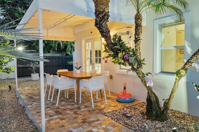 view of patio / terrace featuring outdoor dining area, fence, and french doors