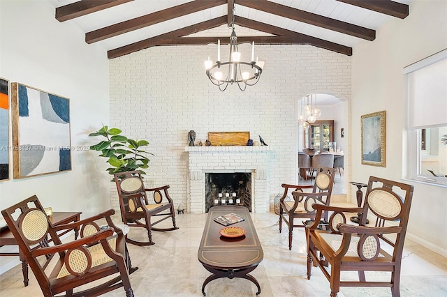 living area with a brick fireplace, high vaulted ceiling, a notable chandelier, and beamed ceiling