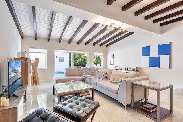 living area with lofted ceiling with beams and baseboards