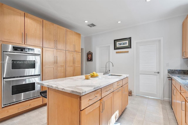 kitchen with light stone counters, visible vents, light brown cabinetry, appliances with stainless steel finishes, and a sink