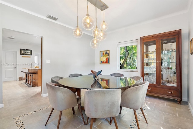 dining space featuring light tile patterned floors, baseboards, and visible vents