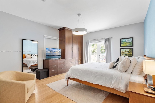 bedroom featuring french doors and light wood-style floors