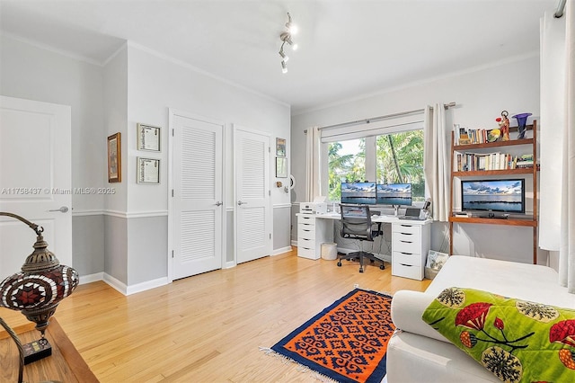 bedroom featuring baseboards, ornamental molding, and wood finished floors