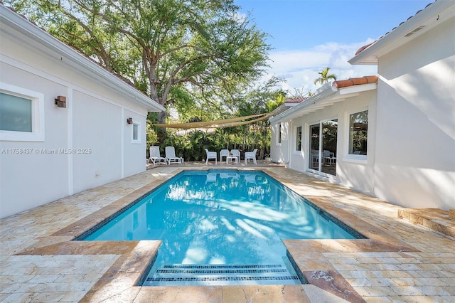 view of swimming pool featuring a fenced in pool and a patio