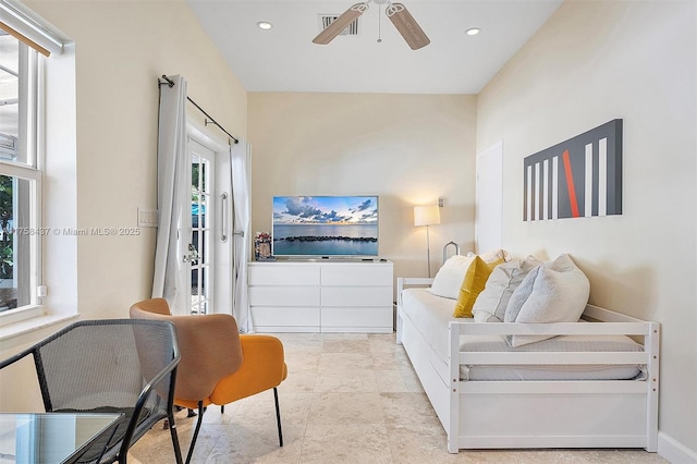 living area with recessed lighting, ceiling fan, and baseboards