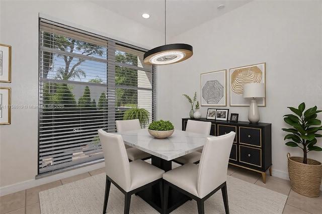 dining area with light tile patterned floors and baseboards