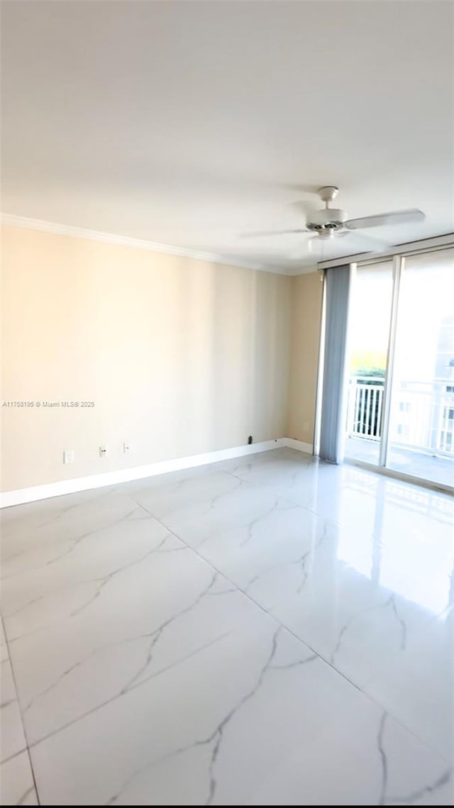 spare room with a ceiling fan, baseboards, marble finish floor, and ornamental molding