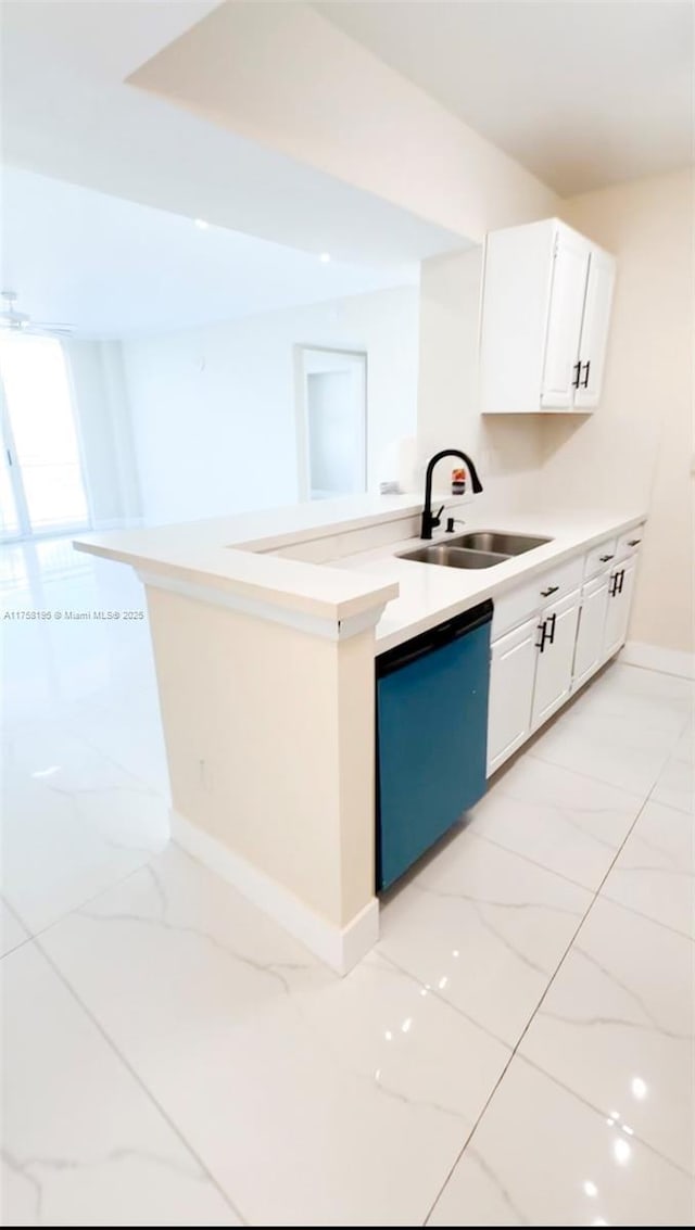 kitchen with dishwashing machine, marble finish floor, light countertops, and a sink