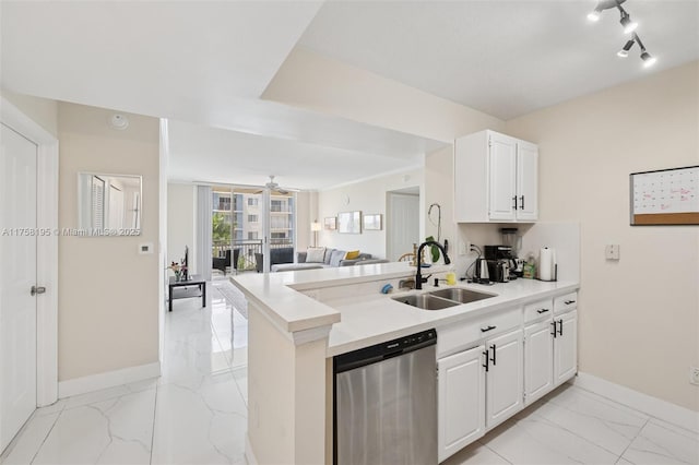 2665 SW 37th Ave Unit 612, Miami, FL 33133 - kitchen with stainless steel dishwasher, light marble finish floors, a sink, baseboards, and a peninsula