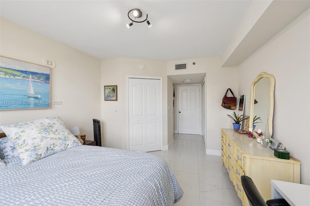 2665 SW 37th Ave Unit 612, Miami, FL 33133 - bedroom with a closet, light marble finish flooring, and baseboards
