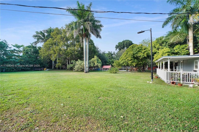 view of yard with covered porch