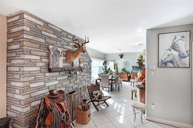 hall featuring light tile patterned floors and baseboards