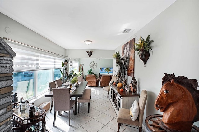 dining space with visible vents and light tile patterned floors