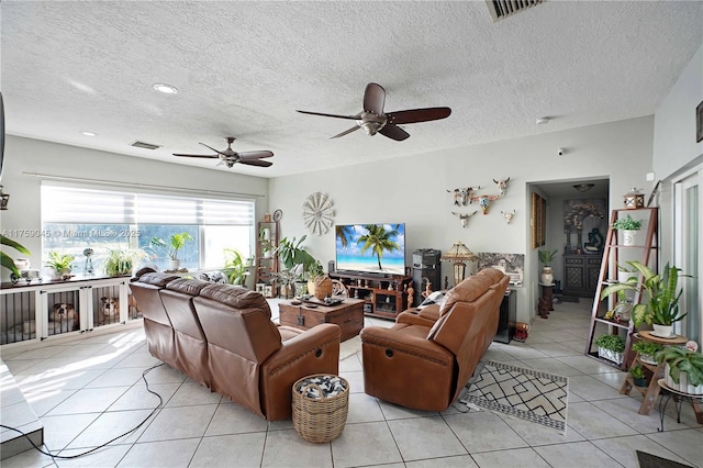 living room with light tile patterned floors, a textured ceiling, and visible vents