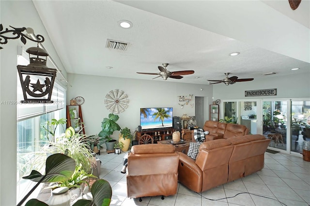 living area featuring a textured ceiling, light tile patterned floors, visible vents, and recessed lighting