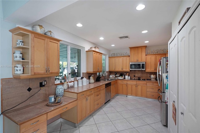 kitchen featuring light tile patterned floors, recessed lighting, visible vents, backsplash, and appliances with stainless steel finishes