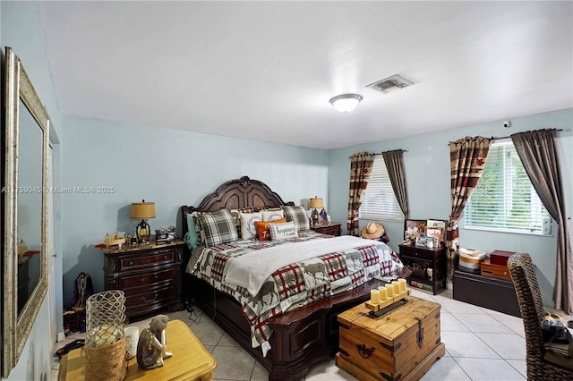 bedroom with light tile patterned floors and visible vents