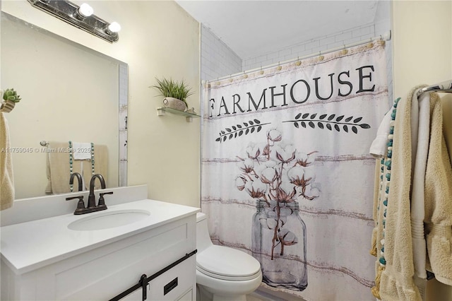 bathroom featuring curtained shower, vanity, and toilet