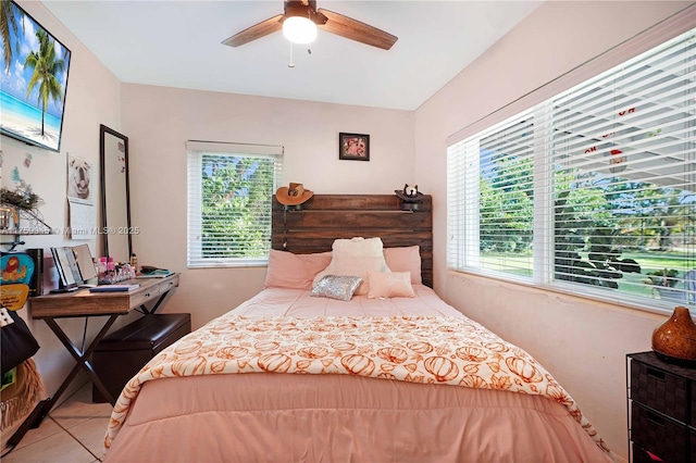 tiled bedroom featuring multiple windows and ceiling fan