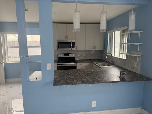 kitchen with marble finish floor, tasteful backsplash, stainless steel appliances, and a sink