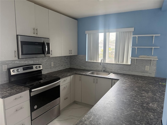 kitchen featuring tasteful backsplash, marble finish floor, stainless steel appliances, open shelves, and a sink