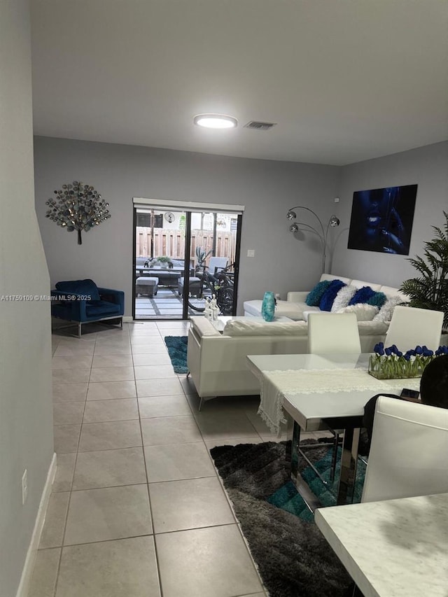 living area with visible vents, baseboards, and light tile patterned floors