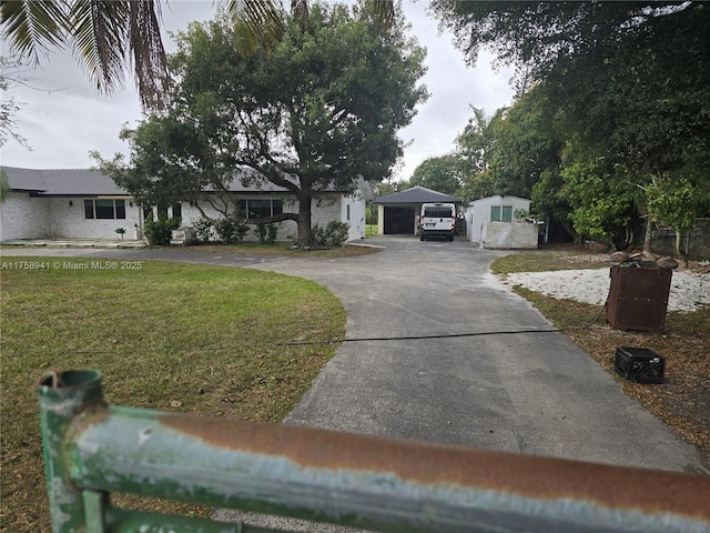 17890 SW 264th St, Homestead, FL 33031 - view of front facade featuring a garage, a front yard, and curved driveway