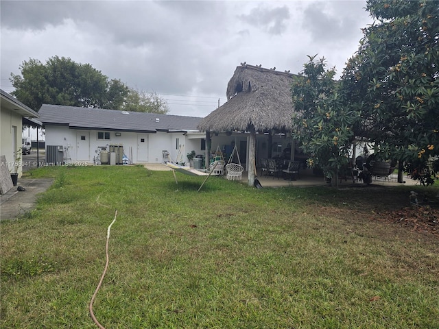 17890 SW 264th St, Homestead, FL 33031 - back of house featuring a lawn and a patio area