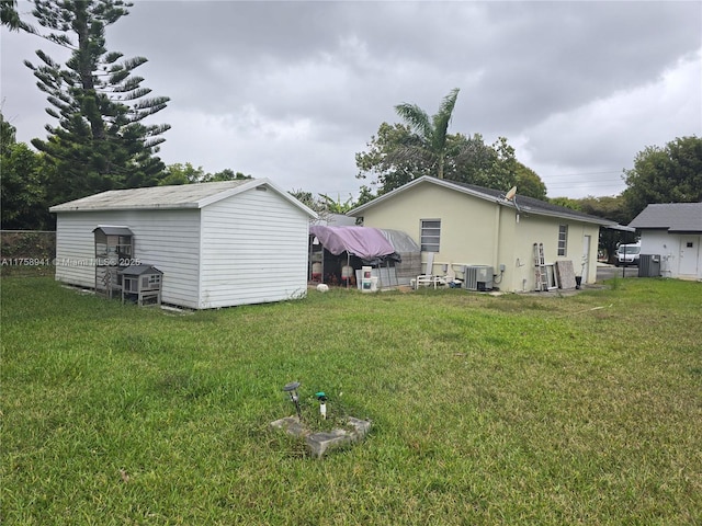 17890 SW 264th St, Homestead, FL 33031 - view of grassy yard featuring a shed, an outdoor structure, and central air condition unit