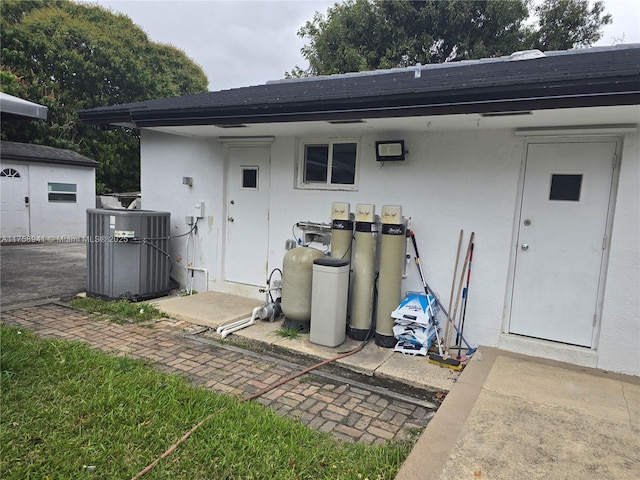 17890 SW 264th St, Homestead, FL 33031 - rear view of property featuring cooling unit, a shingled roof, and stucco siding