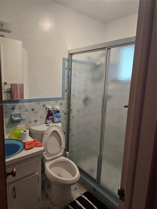 17890 SW 264th St, Homestead, FL 33031 - bathroom featuring tile walls, a stall shower, vanity, toilet, and a wainscoted wall