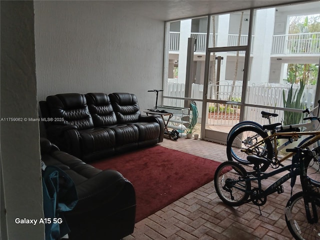 living area featuring brick floor