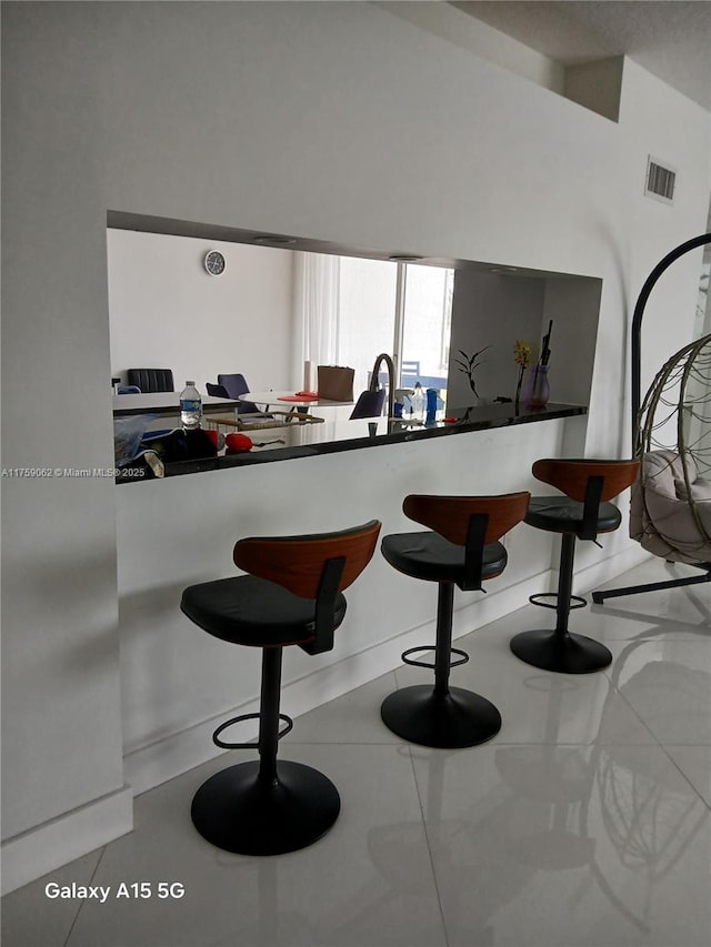 bar featuring tile patterned flooring and visible vents