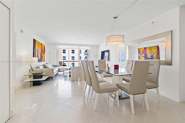 dining room with baseboards and tile patterned floors