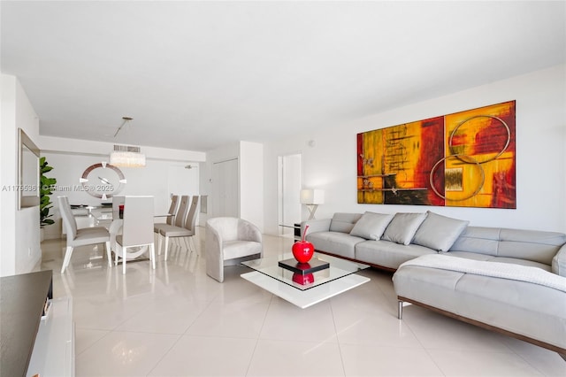 living area with a chandelier and light tile patterned flooring