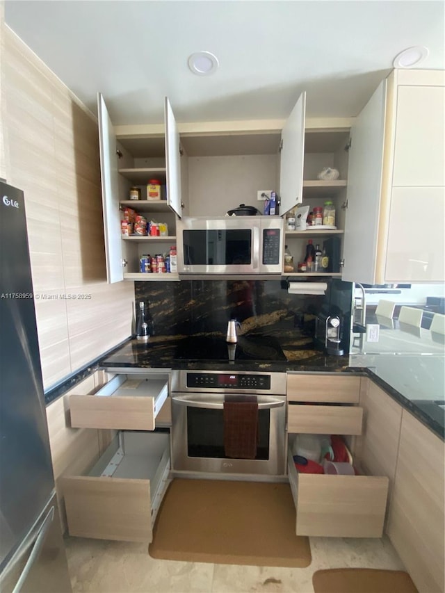 kitchen featuring dark countertops, appliances with stainless steel finishes, open shelves, and backsplash