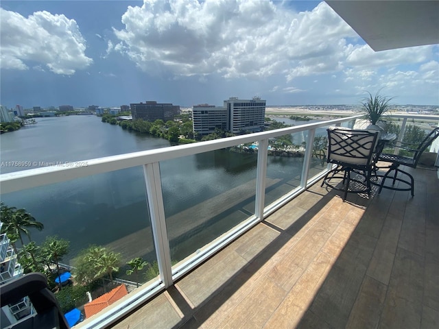 balcony with a view of city and a water view