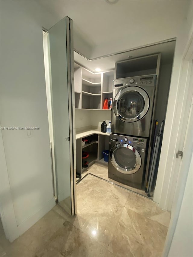 laundry area featuring stacked washer and clothes dryer and laundry area